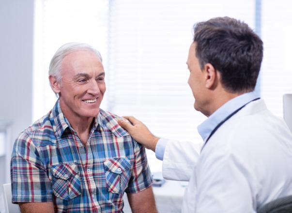 doctor consoling senior man picture id653929054